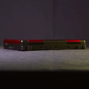 Rear view of the Anbernic RG DS in Black and Crimson Red shown closed at a 45-degree angle, displaying the exterior shell, hinge line, and shoulder trigger buttons