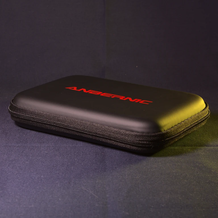 Official Anbernic carrying case for the RG DS dual-screen handheld, shown closed from a 45-degree front angle with the Anbernic logo in red on the lid