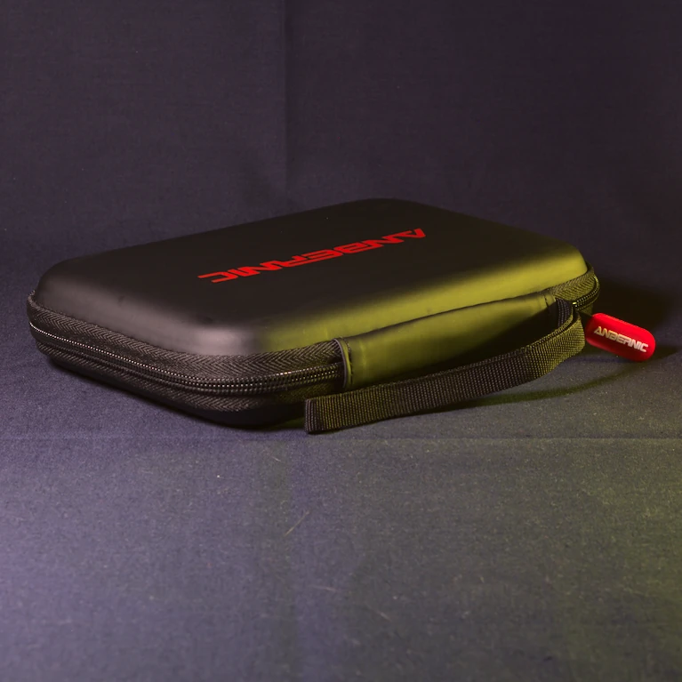 Official Anbernic carrying case for the RG DS, shown closed from a 45-degree rear angle with the red Anbernic-branded zip pull visible